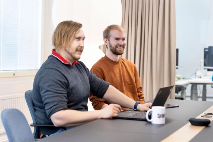 Iloiset työntekijät kokoushuoneessa